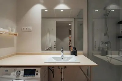 a bathroom with a sink and a mirror at Casa Marina in Barcelona