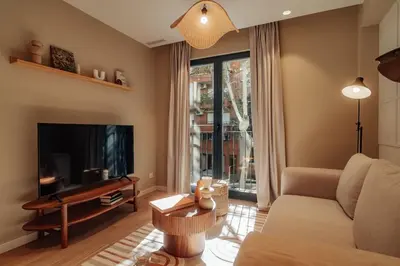 a living room with a couch and a television at Casa Marina in Barcelona