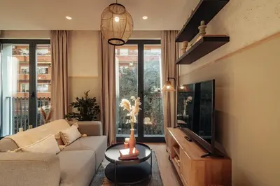 a living room with a couch and a tv at Casa Seda in Barcelona