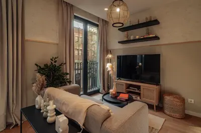 a living room with a couch and a tv at Casa Seda in Barcelona