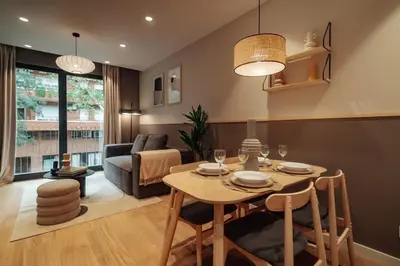 a living room with a table and a couch at Casa Tila in Barcelona