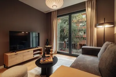a living room with a couch and a television at Casa Tila in Barcelona