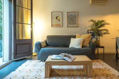 a living room with a blue couch and a coffee table at Dana - Enjoy Apartments Rocafort in Barcelona