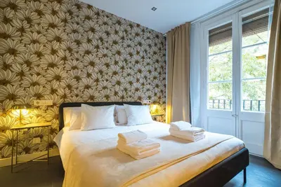 a bedroom with a bed with towels on it at Dana - Enjoy Apartments Rocafort in Barcelona