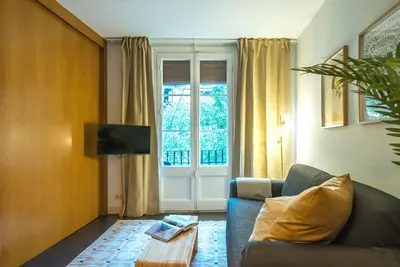 a living room with a couch and a window at Dana - Enjoy Apartments Rocafort in Barcelona