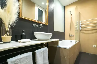 a bathroom with a sink and a toilet and a tub at Dana - Enjoy Apartments Rocafort in Barcelona