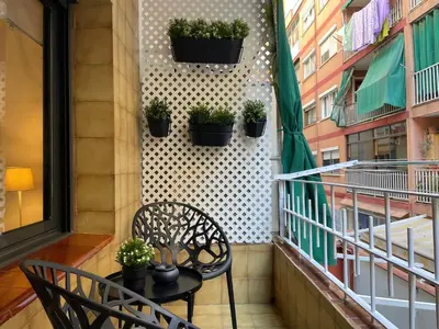 a balcony with a table and chairs and plants at 15 min en metro a Sagrada Familia in Sant Adria de Besos