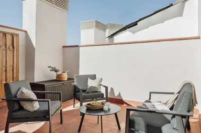 a living room with a table and a mirror at Olivo - 1 bedroom and terrace in Eixample Esquerra in Barcelona