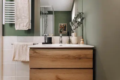 a bedroom with green walls and a bed and a window at Olivo - 1 bedroom and terrace in Eixample Esquerra in Barcelona