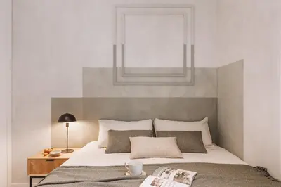 a bedroom with a bed with a wooden headboard at Ferrat - 3 bedrooms in Eixample Esquerra in Barcelona