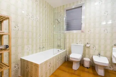 a bathroom with a tub and a toilet and a sink at Canela Homes BARCELONA INDÚSTRIA in Barcelona