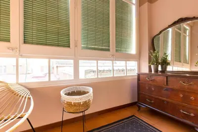 a bedroom with windows and a bed and a dresser at Canela Homes BARCELONA INDÚSTRIA in Barcelona