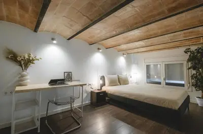 a bedroom with a bed and a desk in it at Chic Poble Nou Loft Terrace & Close to The Beach in Barcelona