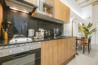 a kitchen with a sink and a stove top oven at Chic Poble Nou Loft Terrace & Close to The Beach in Barcelona