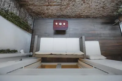 a bench with two white pillows in a room at Chic Poble Nou Loft Terrace & Close to The Beach in Barcelona