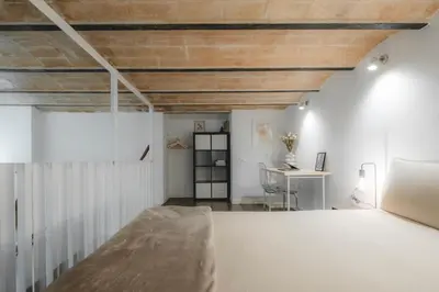 a bedroom with white walls and a wooden ceiling at Chic Poble Nou Loft Terrace & Close to The Beach in Barcelona