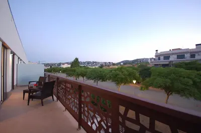 a balcony with a chair and a view of a city at Resort Sitges Apartment in Sitges