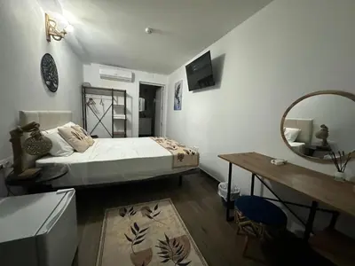 a bedroom with a bed and a mirror and a table at Vilador Barcelona Beach Hotel in Masnou