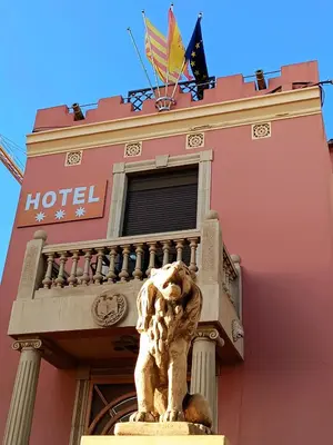 a statue of a lion in front of a building at Hotel Llar de Capitans in Masnou