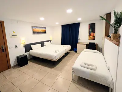a hospital room with two beds and a couch at Hotel Llar de Capitans in Masnou
