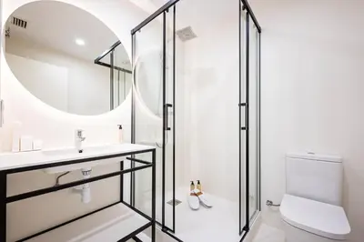 a bathroom with a shower and a sink and a toilet at Sweett - La Gran Via in Barcelona
