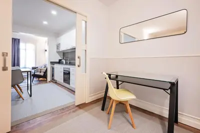 a room with a desk and a yellow chair at Sweett - La Gran Via in Barcelona