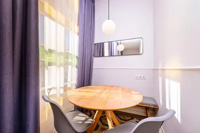 a table and chairs in a room with a window at Sweett - La Gran Via in Barcelona