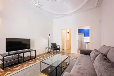 a living room with a couch and a tv at Sweett - La Gran Via in Barcelona