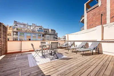 a balcony with chairs and a table on a building at Sweett - Urgell Eixample in Barcelona