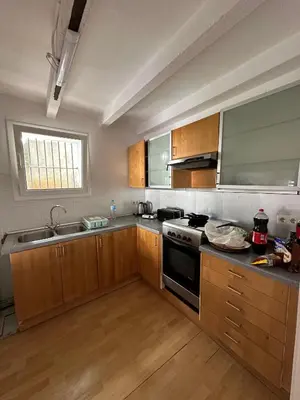 a kitchen with wooden cabinets and a stove top oven at Vista Alegre Casa Rest House in Vallromanas