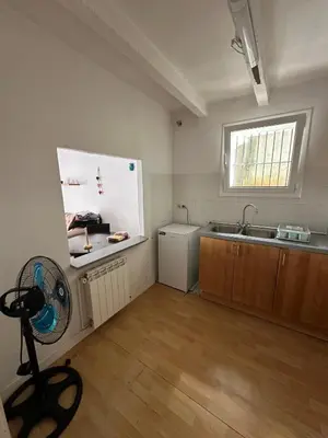 a kitchen with a refrigerator and a sink and a fan at Vista Alegre Casa Rest House in Vallromanas