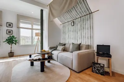 a living room with a couch and a table at Niebla - 1 bedroom in Eixample Esquerra in Barcelona