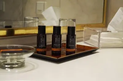 a tray with three bottles of sauce on a table at Paseo de Gracia Residences in Barcelona