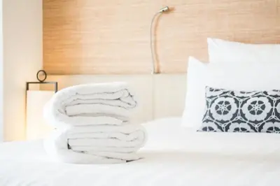 a white bed with a number made out of towels at Paseo de Gracia Residences in Barcelona