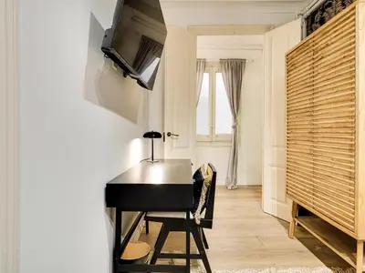 a black piano in a room with a window at Casa modernista en Paseo de Gracia in Barcelona