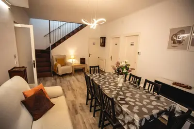 a dining room with a table with a vase of flowers on it at Habitación Sant Jeroni en Casa Camí de les Aigües Monistrol de Montserrat in Monistrol
