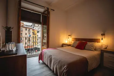 a bedroom with a large bed and a window at Habitación Cavall Bernat en Casa Camí de les Aigües Monistrol de Montserrat in Monistrol