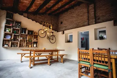 a living room with a couch and a chair and stairs at Habitación Cavall Bernat en Casa Camí de les Aigües Monistrol de Montserrat in Monistrol