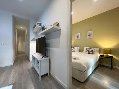 a small bedroom with a bed and a mirror at Stay U-nique Apartments Rossello in Barcelona