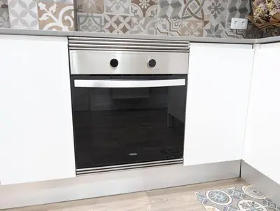 a kitchen with a white oven in a kitchen at New flat in the centre, 10 min from BCN Airport in Cornellà de Llobregat