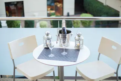 a table with glasses and a bucket on a balcony at Victoria City Center Barcelona in Barcelona