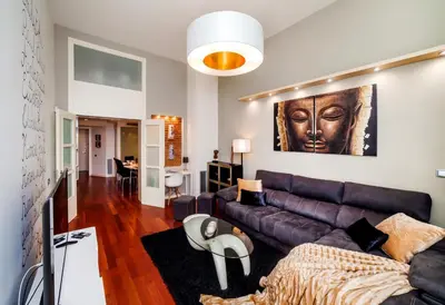 a living room with a brown leather couch at Victoria City Center Barcelona in Barcelona
