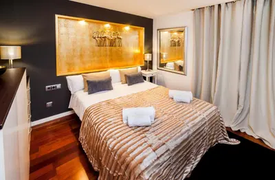 a bedroom with a large bed with two pillows on it at Victoria City Center Barcelona in Barcelona