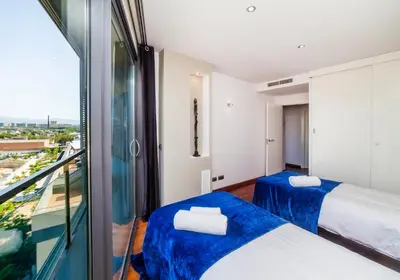two beds in a room with a balcony at Victoria Diagonal Mar Barcelona in Barcelona