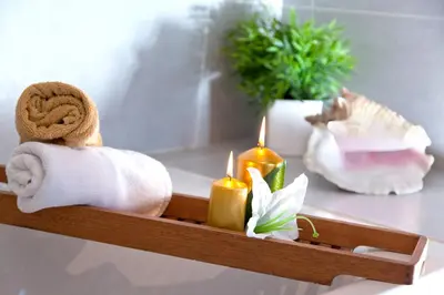a wooden tray with towels and candles on a table at Victoria Diagonal Mar Barcelona in Barcelona