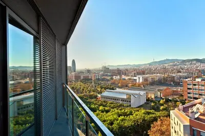 a view of a city from the balcony of a building at Victoria Diagonal Mar Barcelona in Barcelona