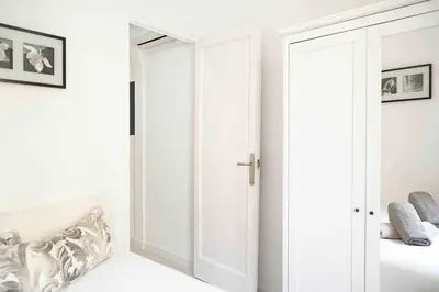 a bedroom with a white door and a bed at SAGRADA FAMILIA SUN Nos preocupa su seguridad in Barcelona