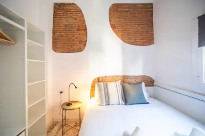 a bedroom with a white bed with two pillows at Fantástico piso en Barcelona in Barcelona