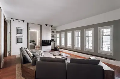 a white room with a bed and a couch at Zuheros - 2 bedrooms in Eixample Dreta in Barcelona