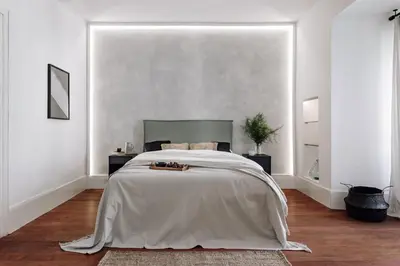 a kitchen with white cabinets and a wooden table at Zuheros - 2 bedrooms in Eixample Dreta in Barcelona
